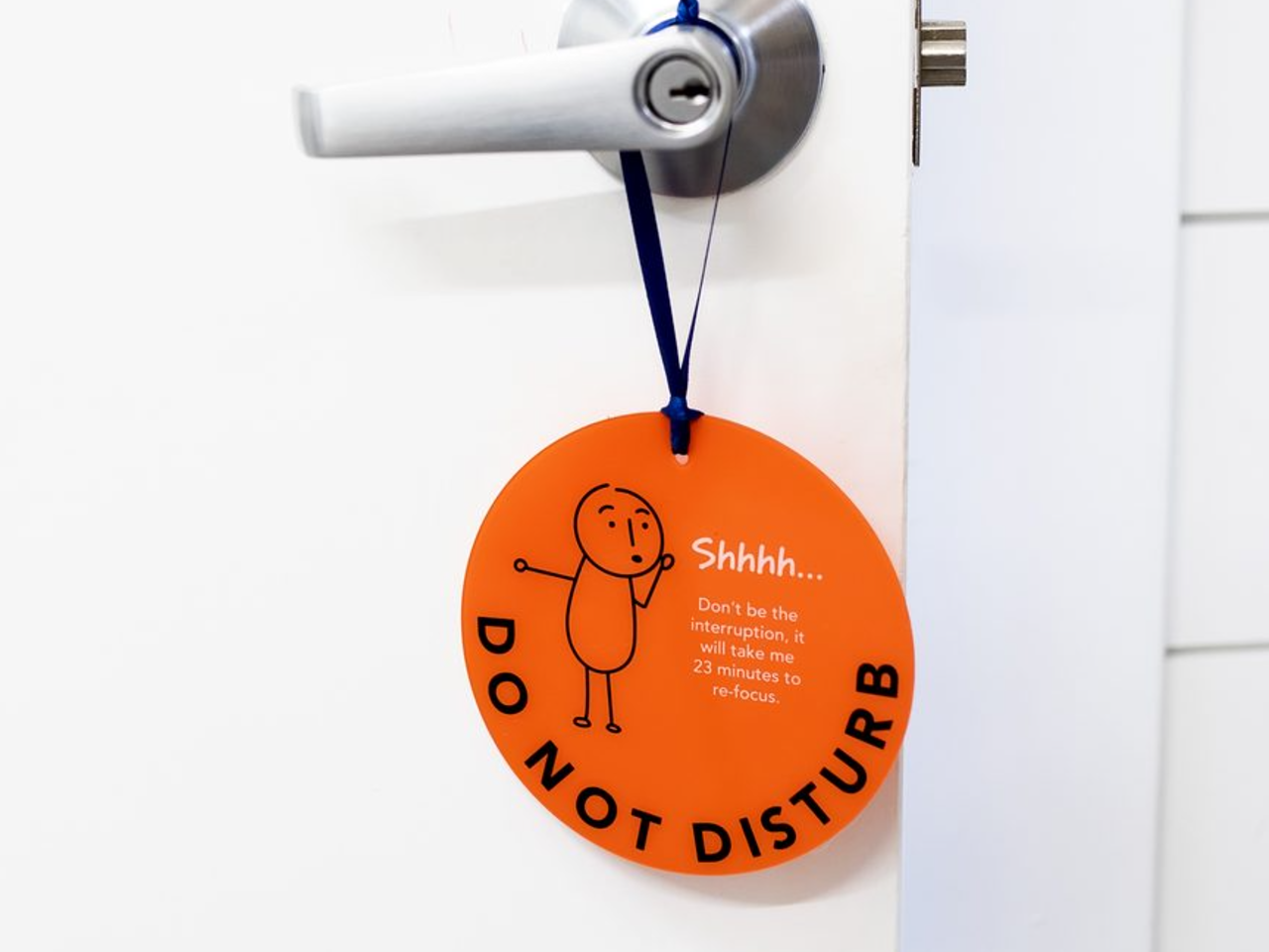The orange Do Not Disturb hanger on a door handle
