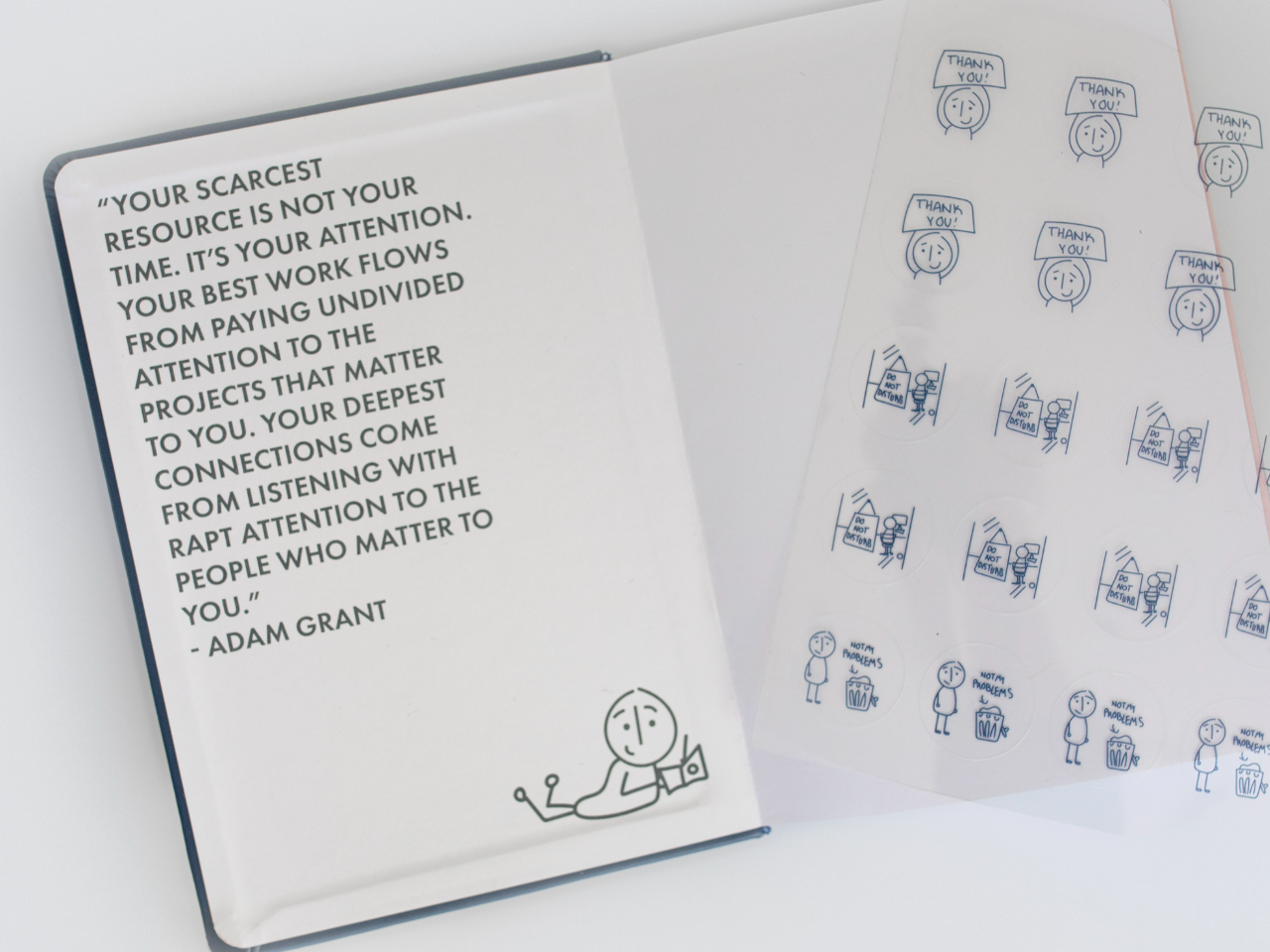 The FocusFit journal open beside its sticker sheet