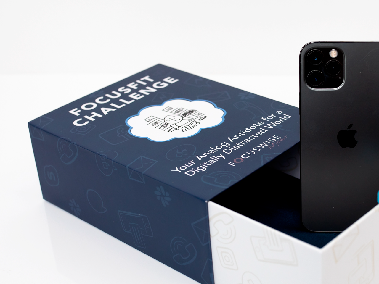 A phone standing inside the open FocusFit box, used as a phone vault